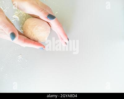 The baker prepares a piece of dough for baking Stock Photo