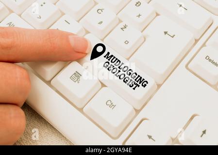 Hand writing sign Mudlogging Geologist, Business concept gather information and creating a detailed well log Lady finger showing-pressing keyboard key Stock Photo