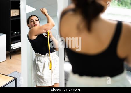 Women Testing Arm Fat Before Liposuction Surgery Stock Photo