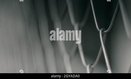 Close up Solid Metallic Wire Mesh Chain link Fence in Vintage Style Steel. Selective focus wire mesh fence Stock Photo
