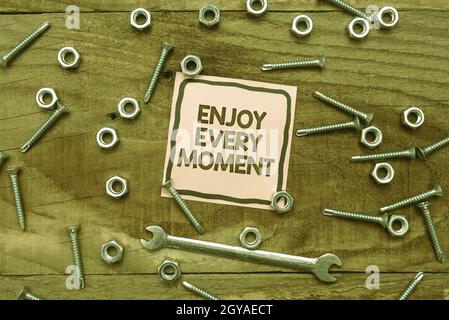 Text sign showing Enjoy Every Moment, Business overview stay positive thinking for personal development New Ideas Brainstoming For Maintenance Plannin Stock Photo