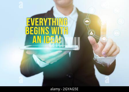 Writing displaying text Everything Begins With An Idea, Word for things can be a reality with actions to take Woman In Suit Holding Tablet Pointing Fi Stock Photo