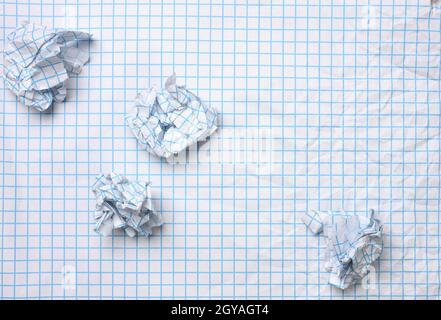 blank crumpled white sheet of paper in a cage and crumpled balls, top view Stock Photo