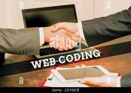 Sign displaying Web Coding, Word for a system of symbols and rules used to represent instructions Two Professional Well-Dressed Corporate Businessmen Stock Photo