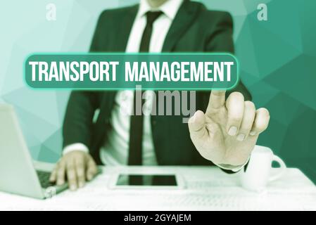 Text sign showing Transport Management, Internet Concept managing aspect of vehicle maintenance and operations Bussiness Man Sitting Desk Laptop And P Stock Photo