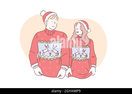 A young loving couple in christmas sweaters with deer are preparing to celebrate a Merry Christmas and Happy New year. Stock Photo