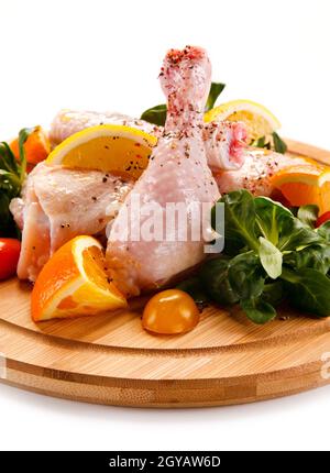 Raw pork chops on cutting board and vegetable Stock Photo