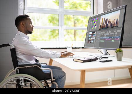 African American Video Editor Tech Job Using Computer Stock Photo