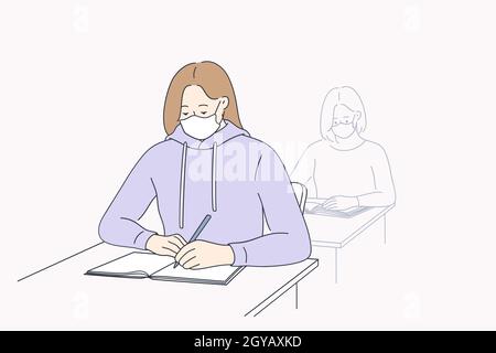 Education and learning during coronavirus pandemic concept. High school student girl wearing protective mask taking notes at lesson during Covid-19 pa Stock Photo
