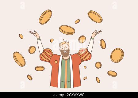 King of coins wealth concept. Young smiling man king in crown cartoon character standing with hands raised up in flying around golden coins feeling ha Stock Photo