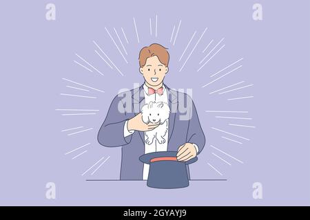 Perfomance, show, magic concept. Young man guy boy magician cartoon character making trick with rabbit bunny from hat. Professional occupation or hobb Stock Photo