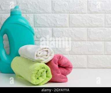 Clean towels and detergent powder on countertop in bathroom Stock Photo -  Alamy