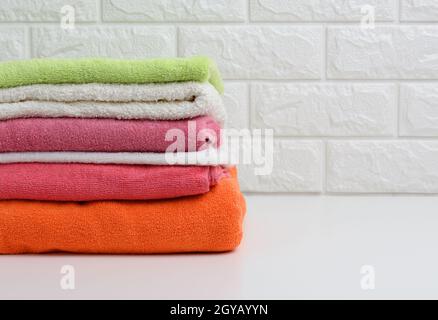 clean folded terry towels on white shelf, bathroom interior Stock Photo