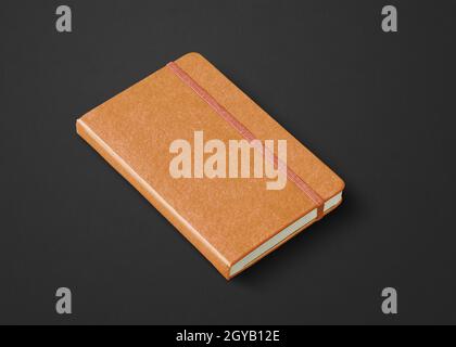 Orange leather closed notebook mockup isolated on black Stock Photo