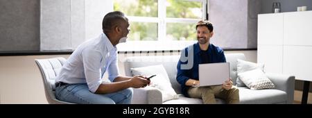 African American Person Talking To Partner Using Laptop Stock Photo