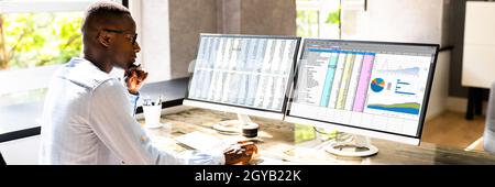 African American Office Employee Auditor Using Spreadsheet Stock Photo