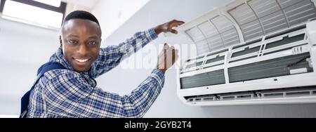 AC Electrician Technician Repairing Air Conditioner Appliance Stock Photo