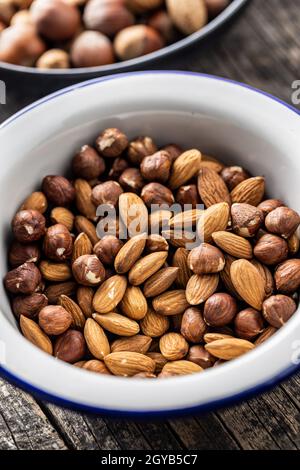 Peeled hazelnuts and almonds. Sweet nuts in bowl. Stock Photo