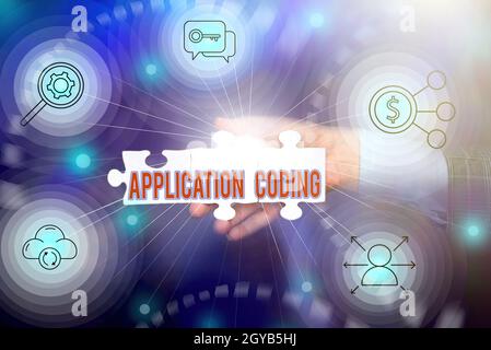 Text caption presenting Application Coding, Conceptual photo process by which a mobile app is developed for mobile Hand Holding Jigsaw Puzzle Piece Un Stock Photo