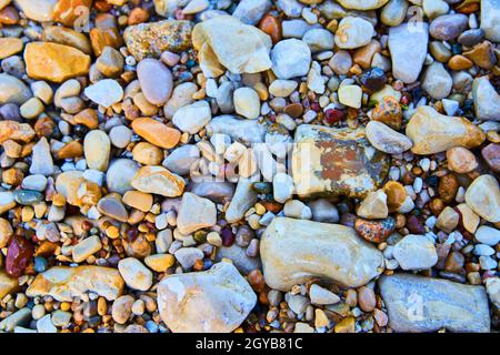 Assortment of colorful and shiny wet pebbles Stock Photo