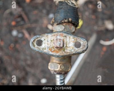 Old plumbing water tap with a metal valve. Equipment. Plumbing work. Water pipe repair. Plumber. Place for text. Background image. Stock Photo
