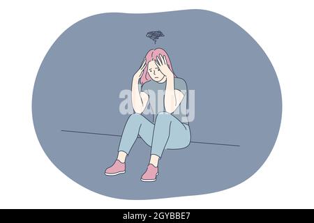 Sadness, mental depression, bad news concept. Young unhappy woman sitting touching head with hands feeling depressed with thoughts after negative even Stock Photo