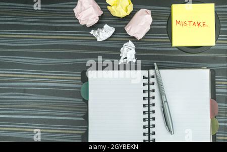 Mistake written on sticky notes. Learning, wrong, blooper, error, regret sayings background. Fault, defect, careless, lesson correction and reconcilia Stock Photo