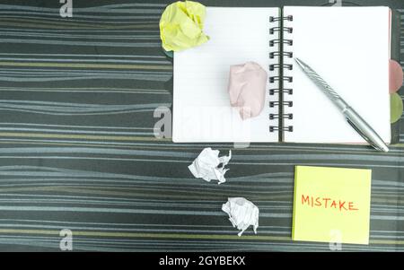 Mistake written on sticky notes. Learning, wrong, blooper, error, regret sayings background. Fault, defect, careless, lesson correction and reconcilia Stock Photo