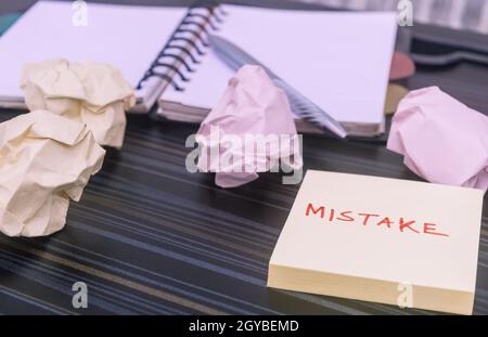 Mistake written on sticky notes. Learning, wrong, blooper, error message, regret sayings background. Fault, defect, careless, lesson correction and re Stock Photo