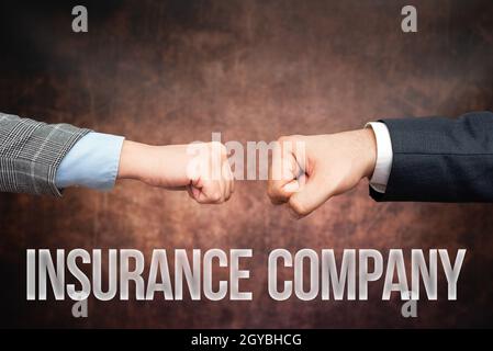 Handwriting text Insurance Company, Conceptual photo company that offers insurance policies to the public Two Professional Well-Dressed Corporate Busi Stock Photo