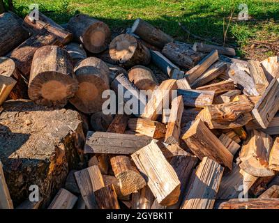 Wood chopped with an ax for heating a rural house. Wood burning stove. Heating season. Pine forest. Industrial logging. Sawmill. Pine sawing. Environm Stock Photo