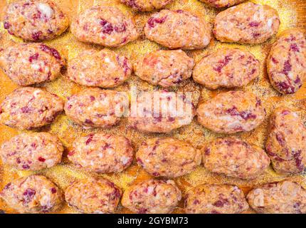 Raw meat cutlets on a wooden cutting board. Food photo. Meat dish. Preparing food. Home kitchen. Recipe. Raw minced meat. Chicken's meat. Cutlets. Coo Stock Photo