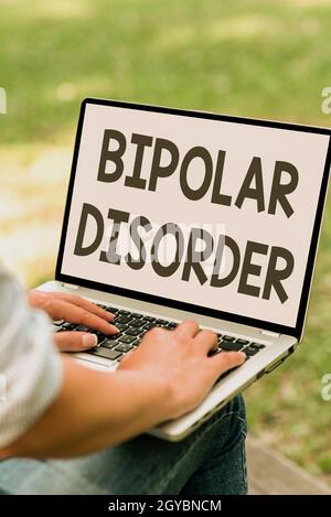 Hand writing sign Bipolar Disorder, Word for mental illness that brings severe high and low moods Online Jobs And Working Remotely Connecting People T Stock Photo