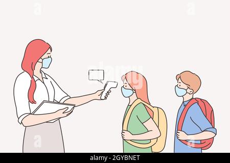 Measuring temperature in school during pandemic concept. Teacher woman using electronic thermometer for measuring body temperature of pupils coming to Stock Photo