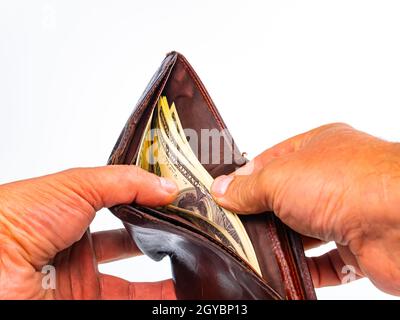 Hands count money American dollars in a man's wallet. Man's wallet with money. American dollar currency. Recalculation of salaries in the wallet. Busi Stock Photo