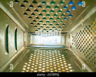 Kitchen tool aluminum hand grater inside view. Manual kitchen tools. Grater for chopping vegetables and fruits. Cooking food. Chef's job. Culinary spe Stock Photo