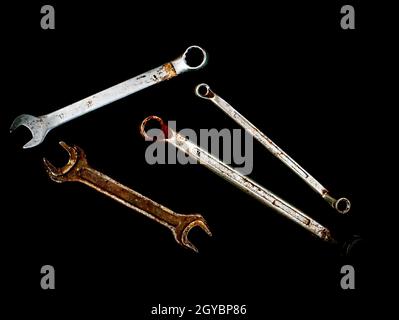 Hand tools metal wrenches on a black background. Hand-held locksmith tools. Wrench. Tighten screws and nuts. Locksmith work. Mechanic. Work. Place for Stock Photo