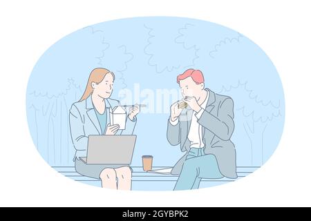 Street food, Unhealthy eating, calories concept. Young business couple office workers sitting and eating burger and noodles in park during lunch break Stock Photo