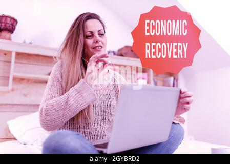 Conceptual caption Economic Recovery, Concept meaning rise of business activity signaling the end of a recession Casual Internet Surfing, Student Rese Stock Photo