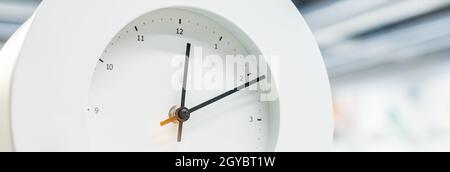 round clock with black arrows and numbers. big clock hanging on a wall. deadline,time management concept and lunch time,WAKE UP.web banner. Stock Photo