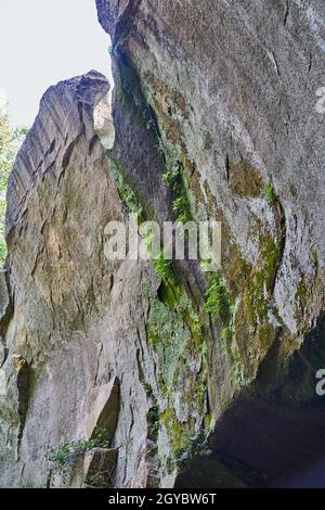 Cliff overhang with bits of moss and lichens growing on it Stock Photo
