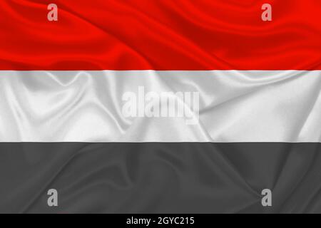 3D Flag of Yemen on wrinkled fabric. Stock Photo