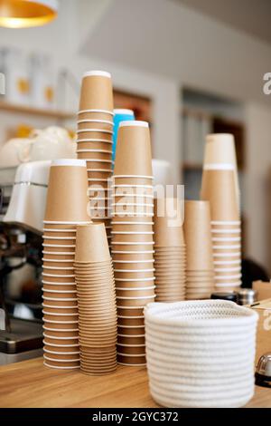 lot of drinking disposable paper cups in piles. stack of paper cup in the cafe Stock Photo