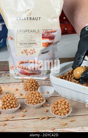 Sao Paulo, SP, Brazil, october 5 2021. Dulce de leche brigadiers (brigadiers) with salted caramel. In the background, crispearls Callebaut packaging. Stock Photo