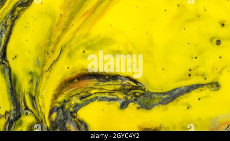 Shot of a yellow abstract painting with black breaches Stock Photo