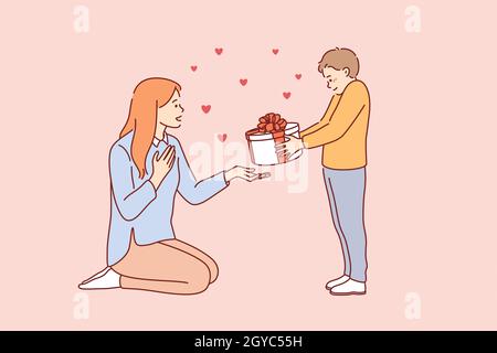 Celebrating Happy Mothers day concept. Small smiling boy cartoon character standing giving present box to his young mother for holiday vector illustra Stock Photo