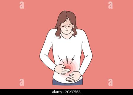 Diarrhea or constipation, problems with health concept. Young sad Woman standing feeling pain in stomach touching it with hands having Abdomen disease Stock Photo