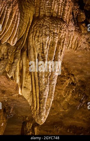 Clouse up of ripples in stalactite of cave stuck to ceiling Stock Photo