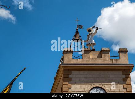 Montepulciano, Tuscany, Italy. August 2020. Daytime footage in the historic center. A small tower is surmounted by the automaton of the pulcinella cha Stock Photo
