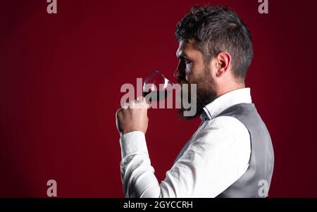 Restaurant. Degustation. Sommelier with Red wine. Male with alcohol. Bearded man with wine glass. Copy space for advertising Stock Photo